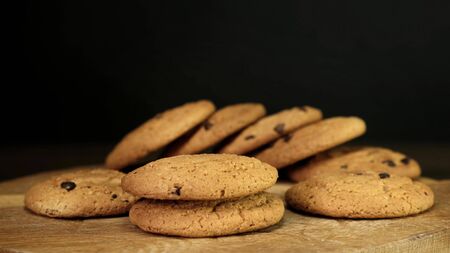 Stack of Chocolate chip cookies on wooden background. Close up