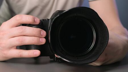 Hand pressing the shutter button on the cameraの写真素材