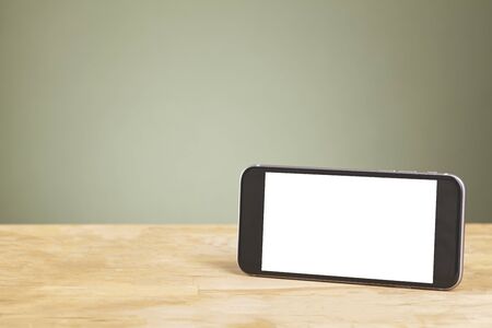 Smart phone with isolated screens on old wooden desk.