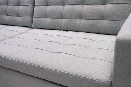 Grey textile modern sofa front view. Close up