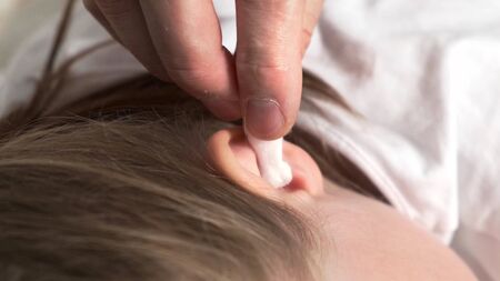 Put in sick ear by white cotton swab.の写真素材