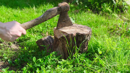 Hand Worker chopping wood outdoor close upの写真素材