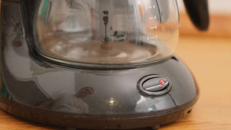 Finger presses Button on coffee machine Close upの写真素材