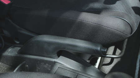 Putting on the hand brake of a car Close up