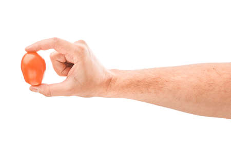 Cherry tomatoes isolated on white with male handの写真素材