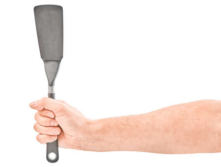 Male hands holding a spatula for frying. Isolated on gray background.の写真素材