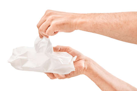 Man cleaning his hand with wet tissue isolated on white backgroundの写真素材
