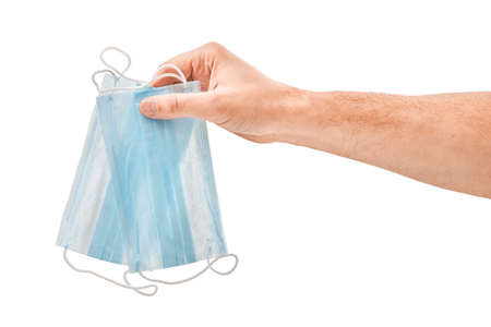Male hand hold medical mask on a white isolatedの写真素材