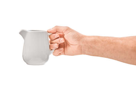 male hand holds a white teapot, isolatedの写真素材