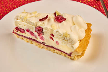a piece of white cake with cherry close upの写真素材