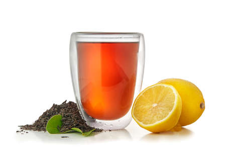 tea in cup with green leaf and lemon isolated on white backgroundの写真素材
