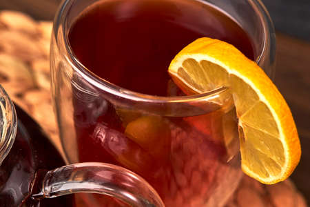 cup of tea, glass teapot, lemon on a wooden tableの写真素材