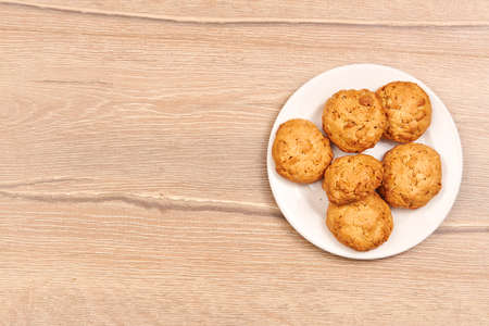 Cookies in white ceramic dish on wood boardの写真素材