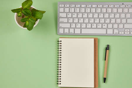Paper for notes on green table in the office. Flat lay, top view, copy space concept.の写真素材