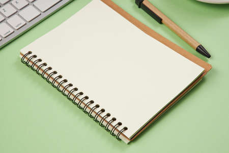 Paper for notes on green table in the office. Flat lay, top view, copy space concept.の写真素材