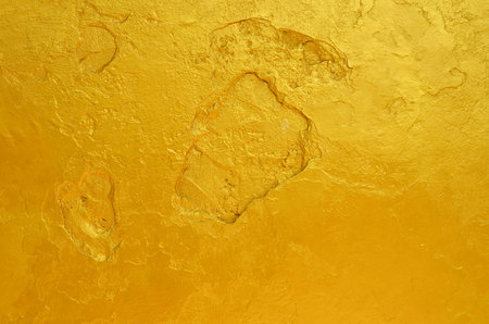 golden statue paintings cracked texture backgroundの写真素材