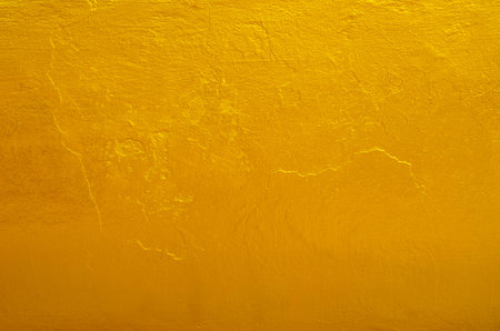 Yellow gold texture background on the back of buddha statue in temple