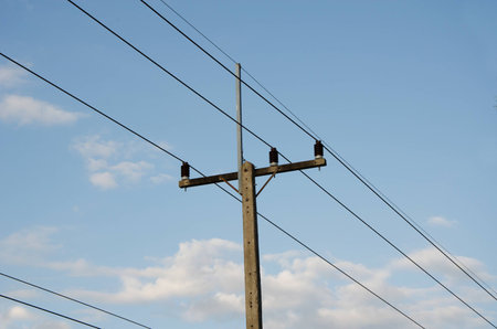 electrical post by the road against blue skyの写真素材