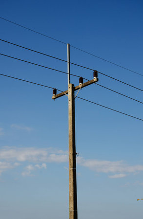 electrical post by the road against blue skyの写真素材