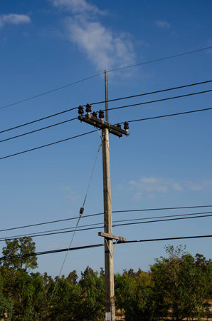 electrical post by the road against blue skyの写真素材