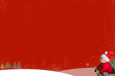 lovely baby and red merry Christmas background with snow flakesの写真素材
