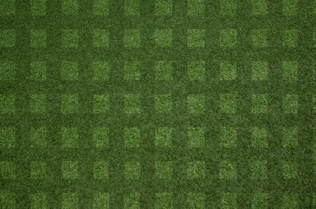 closeup fresh green grass texture block pattern background for football fieldの写真素材