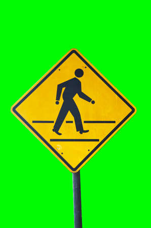 yellow signs to beware human walk cross road isolated greenの写真素材