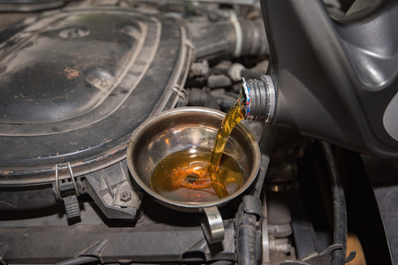 oil change, pouring oil to car engineの写真素材