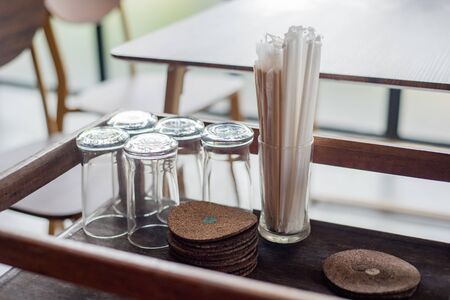 empty glass and drinking straws on tableの写真素材