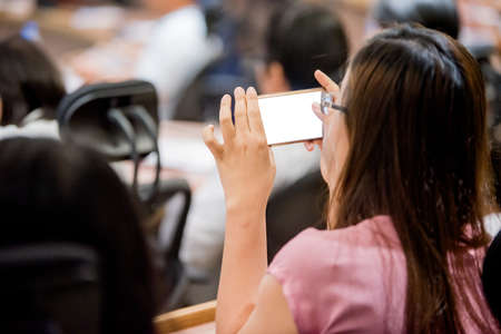 Business people working on laptop computer and phone in meeting roomの写真素材
