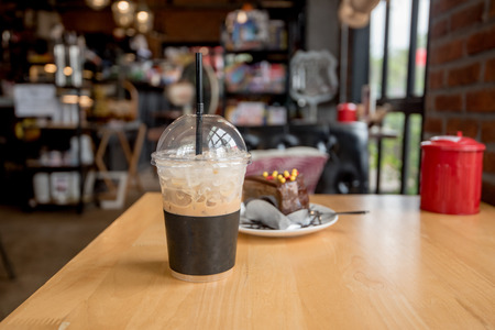 ice coffee take away and cake on wooden backgroundの写真素材