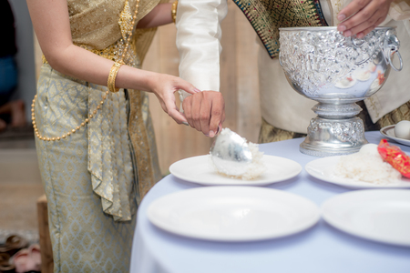give alms to a Buddhist monk in wedding day, Thailand weddingの写真素材