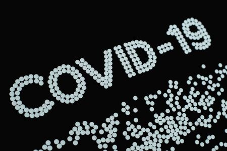 Covid-19 - Novel Coronavirus made by many medicine pills isolated on blackの写真素材