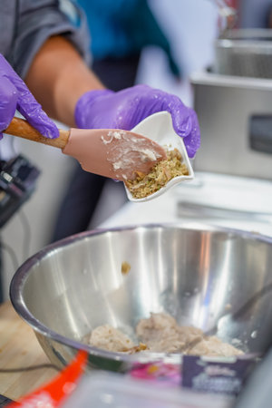 Chef hands fried nuggets at kitchen restaurant.