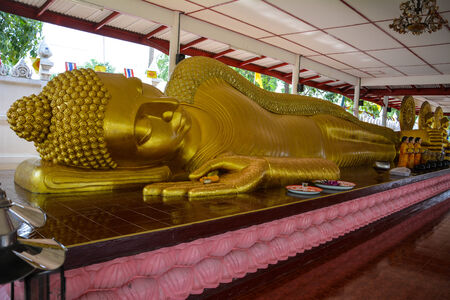 Sleeping Buddha statue in Thailand architecture color is goldの写真素材