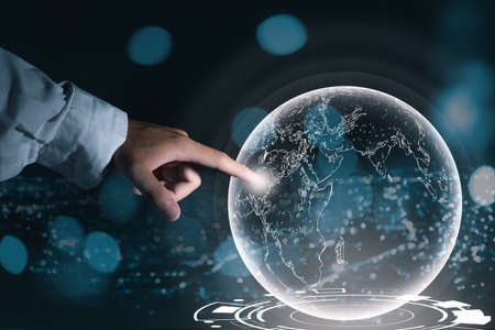 Business men hand finger touch the 3D globe network to connect and exchanges information with people all over the world, communication technology and business concepts.の写真素材