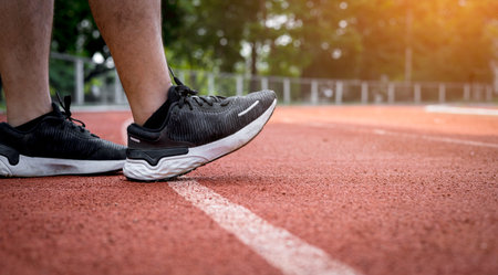 Athletes preparing to run on the field, starting to run forward, setting goals for exercise and maintaining health, planning challenges, determination to change oneself, outdoor sports, Stadium.の写真素材
