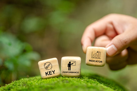 Wooden cube block with KPI (KEY, Performance and Indicator) Key performance indicators to assess success or achieve goals. Indicators or data to review and improve business concepts.の写真素材