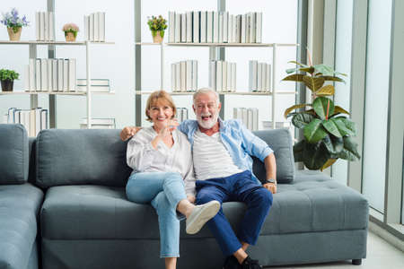 Elderly senior family people sitting in modern living room together with smile happy and romantic emotion.の写真素材