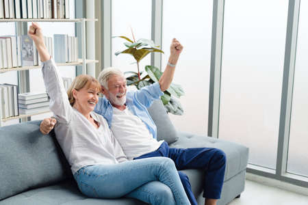 Elderly senior family people sitting in modern living room together with smile happy and romantic emotion.の写真素材