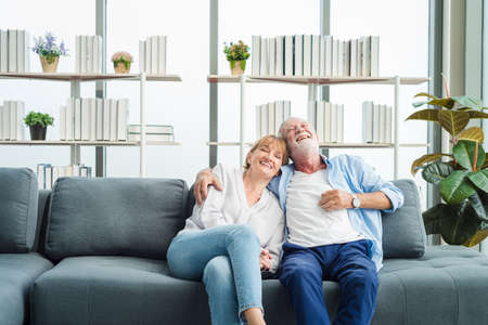 Elderly senior family people sitting in modern living room together with smile happy and romantic emotion.の写真素材