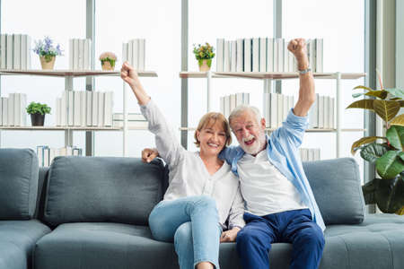 Elderly senior family people sitting in modern living room together with smile happy and romantic emotion.の写真素材