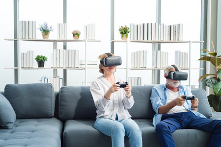 Elderly senior family people sitting in modern living room together playing game on virtual reality device with exciting and fun.の写真素材