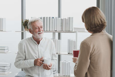 Portrait of senior elderly couple in casual outfit drink a cup of coffee together with happy and...