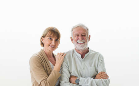 Portrait of senior elderly couple in casual outfit smiling with happiness in white background.