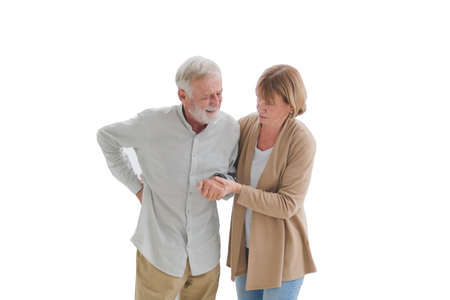 Senior elderly people in casual outfit help her husband from get hurt on back with unhappy and painful emotion in white background.の写真素材
