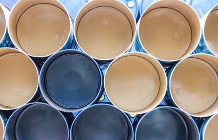 gallon chemical drums in a storage yard awaiting recyclingの写真素材