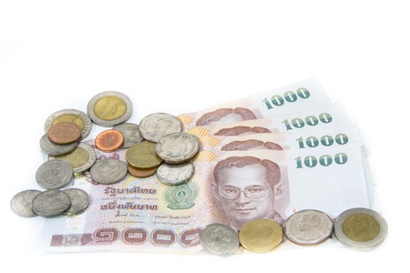Thailand paper currency and coins isolated over whiteの写真素材