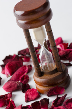 Dried rose petal with sandglass. Time is runing out.