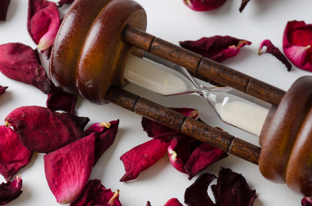 Dried rose petal with sandglass. Time is runing out.